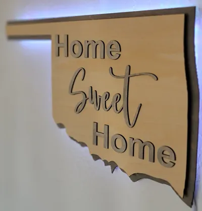 A workbench with paints, clamps, and other tools for making decor and signs.